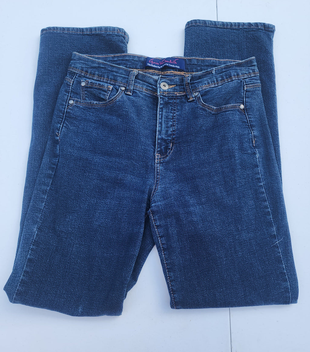 Women's blue jeans laid flat, medium wash denim with belt loops and button closure