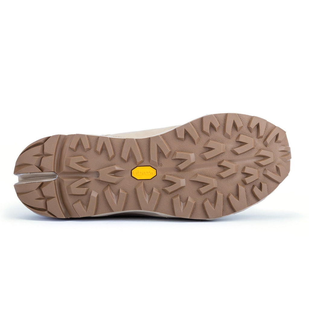 Outsole tread of tan 6-inch waterproof hiking boot with grippy multidirectional lugs