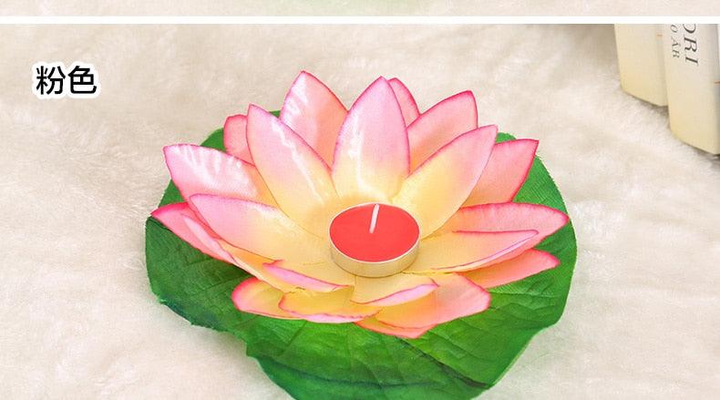 Pink lotus LED floating candle with green base and lit purple center