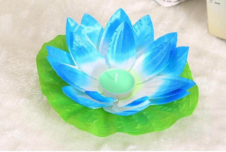 Blue and green lotus-shaped floating LED candle with glowing teal center light