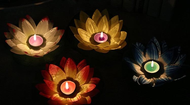 Lotus-shaped floating LED candles in gold and red petals with glowing tea-light centers