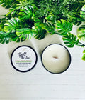 Wood wick candle in dark round tin with cream wax and lit wick tab