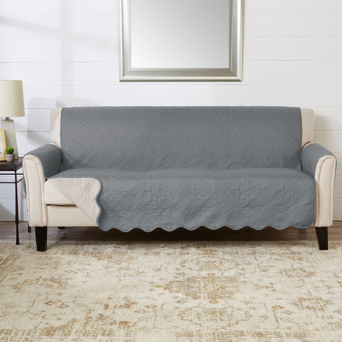 Smoke blue loveseat protector with medallion quilting and scalloped hem