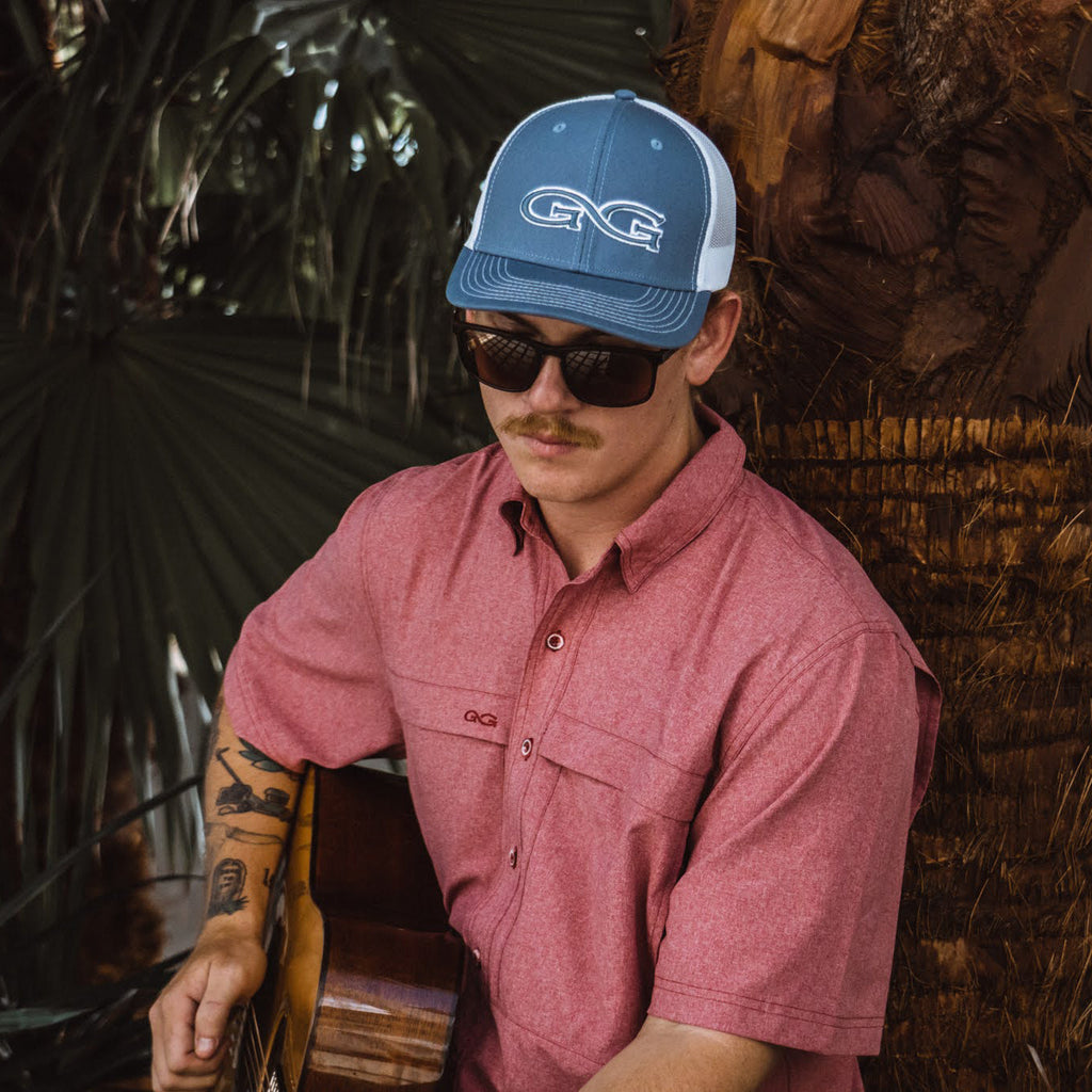Crimson short-sleeve button-up shirt with chest pocket, worn by model