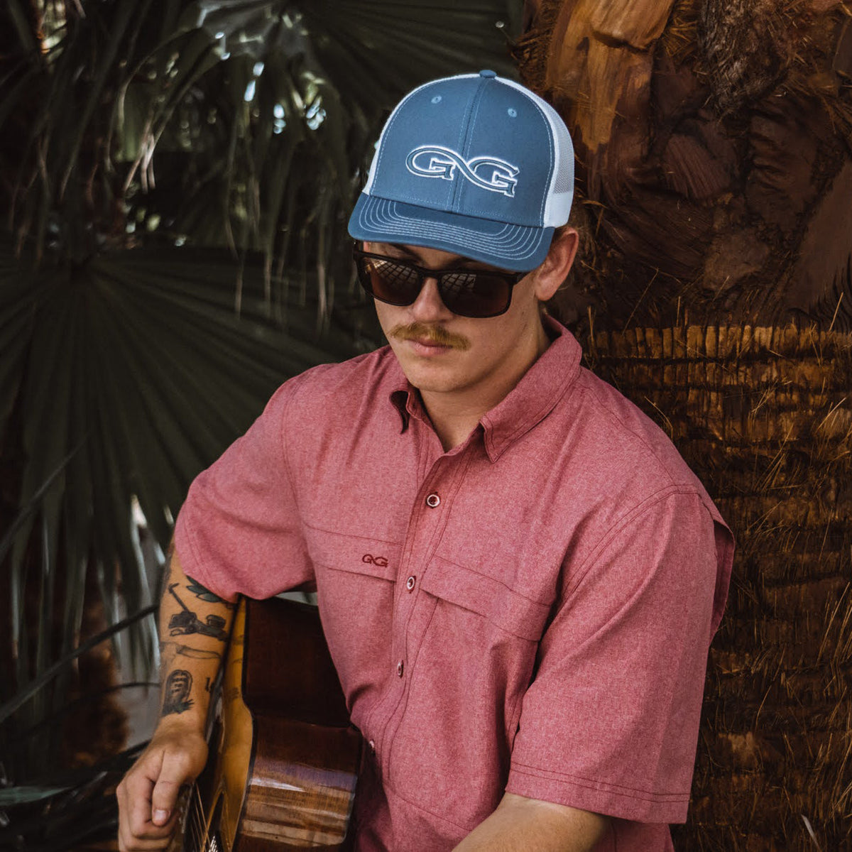Crimson short-sleeve button-up shirt with chest pocket, worn by model