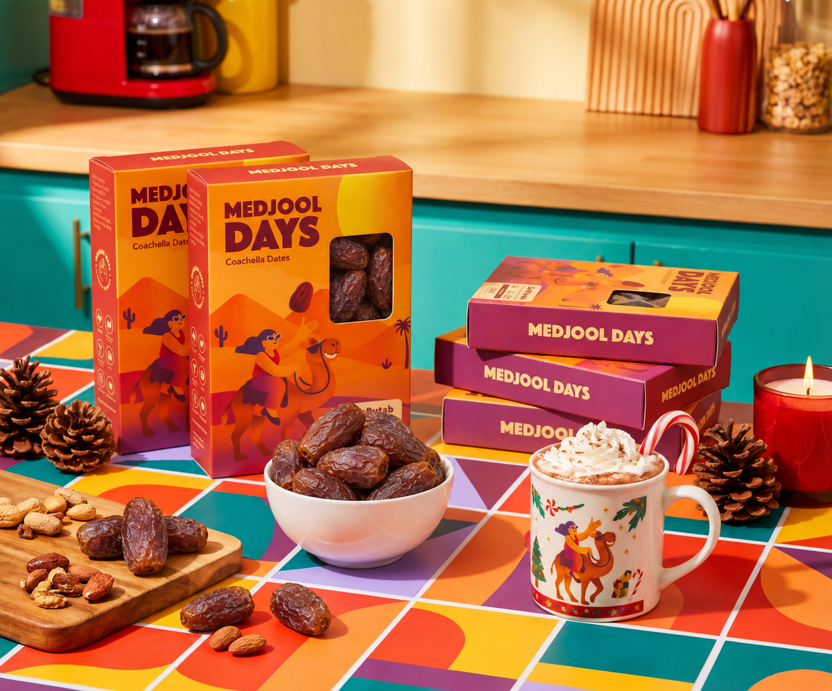 Soft Medjool dates gift boxes and a bowl filled with dark red dates