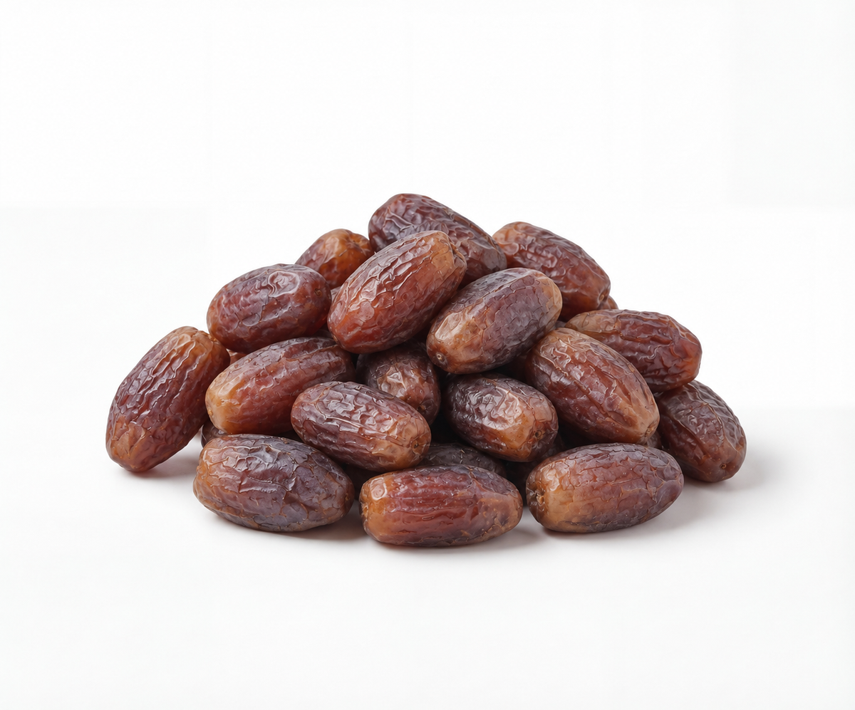 Pile of dark purple Medjool dates on a white background
