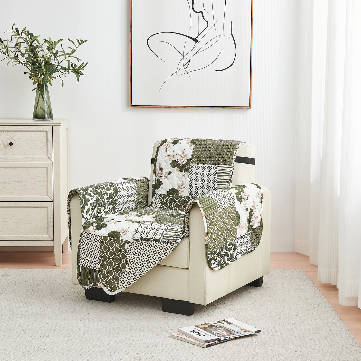Reversible furniture protector on an armchair with green and cream geometric and floral patchwork.