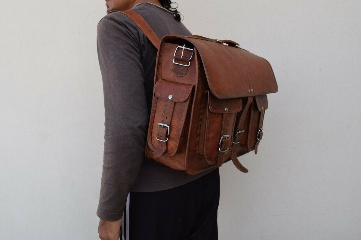 Brown leather messenger backpack worn over shoulder with front buckle pocket details