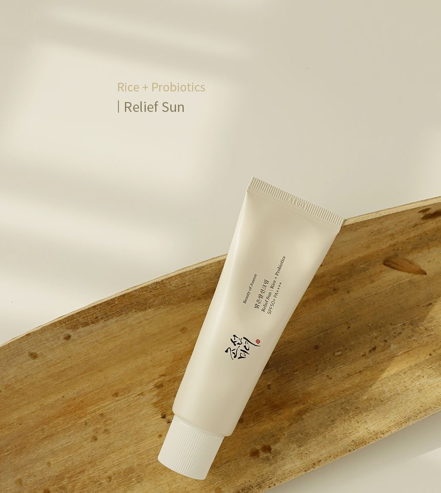 Cream SPF sunscreen tube, angled view with printed label and small nozzle