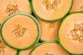 Cantaloupe seed slices with visible seed chambers and pale tan seeds