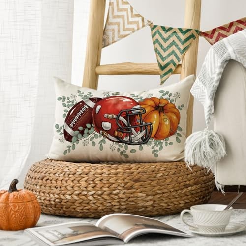 Fall pillow cover with football helmet and orange pumpkin print and green leaf sprigs