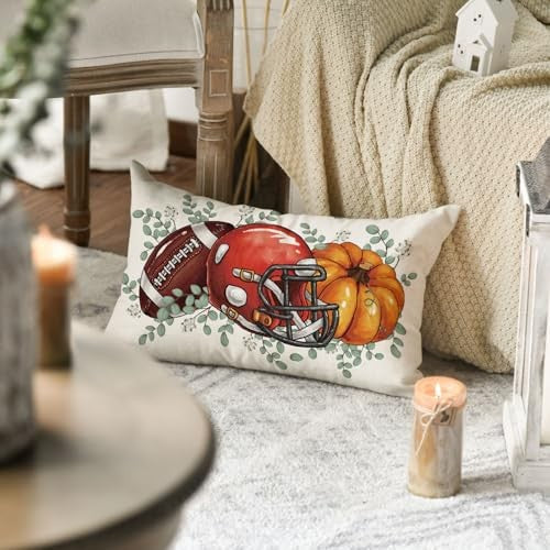 Fall decorative pillow cover with football helmet and pumpkin graphic on cream fabric