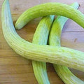 Green cucumber with pale ridges, cut ends visible