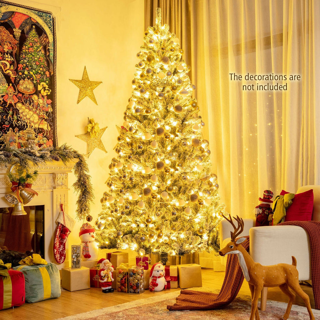 Warm white pre-lit snow flocked Christmas tree with full branches and metal stand