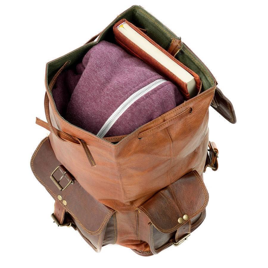 Open brown leather hiking backpack with notebook and zip pocket inside