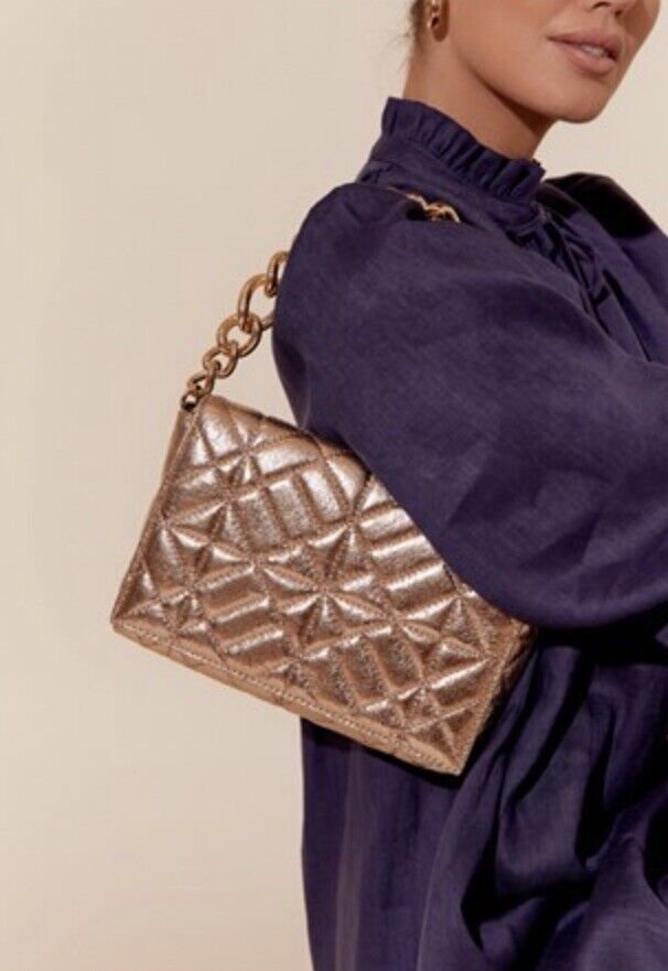 Gold metallic quilted shoulder clutch with chain strap and snap-flap closure