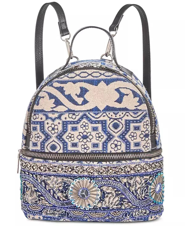 Steve Madden Duchess backpack with two black straps and blue patterned front panel