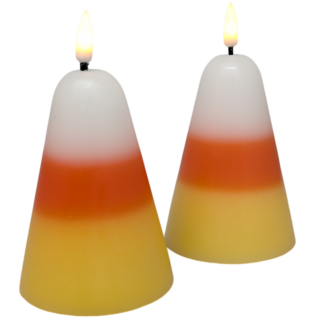 Pair of lit candy corn wax candles with three-color gradient and flames