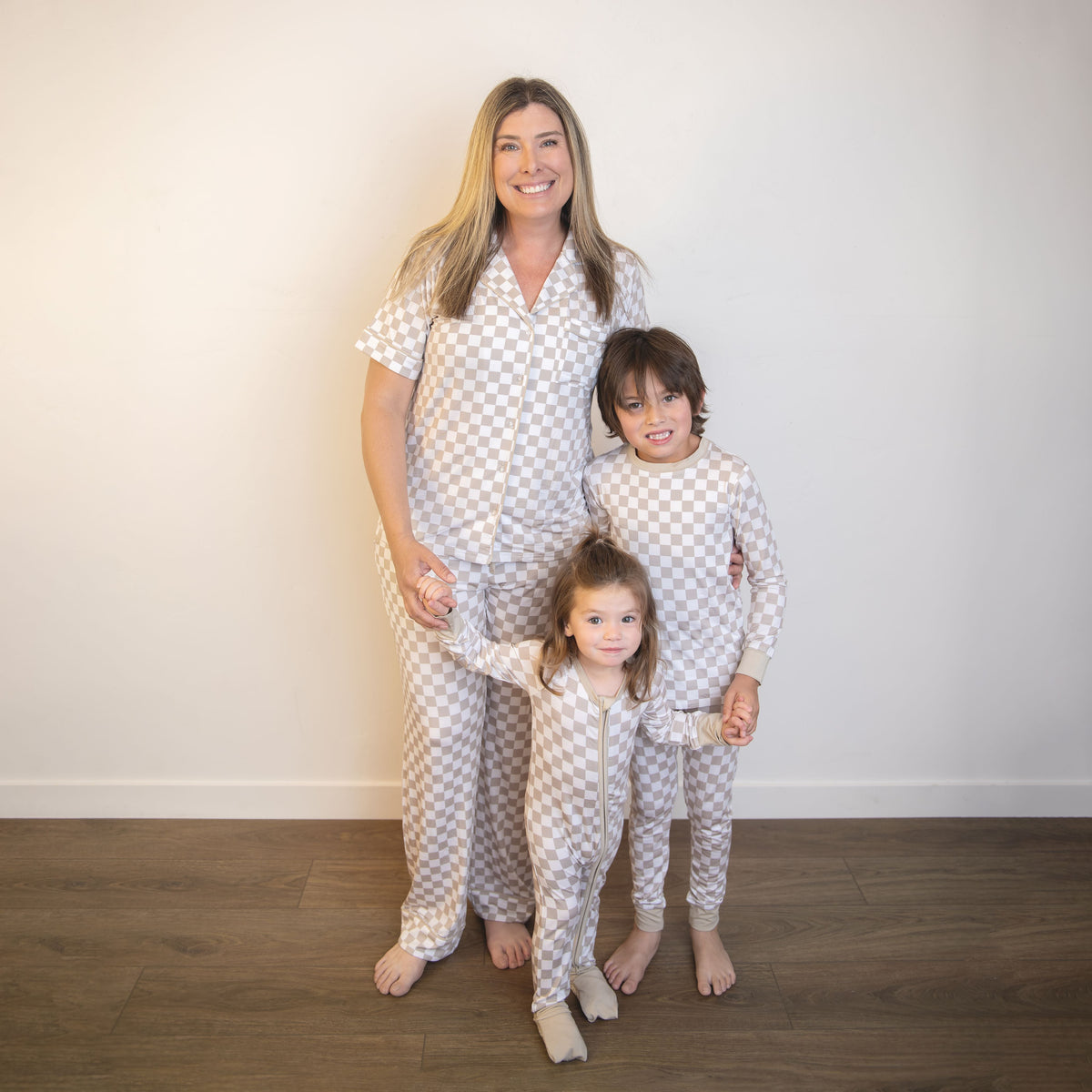 Matching checkered hooded zippy coveralls for adult and child; beige and white
