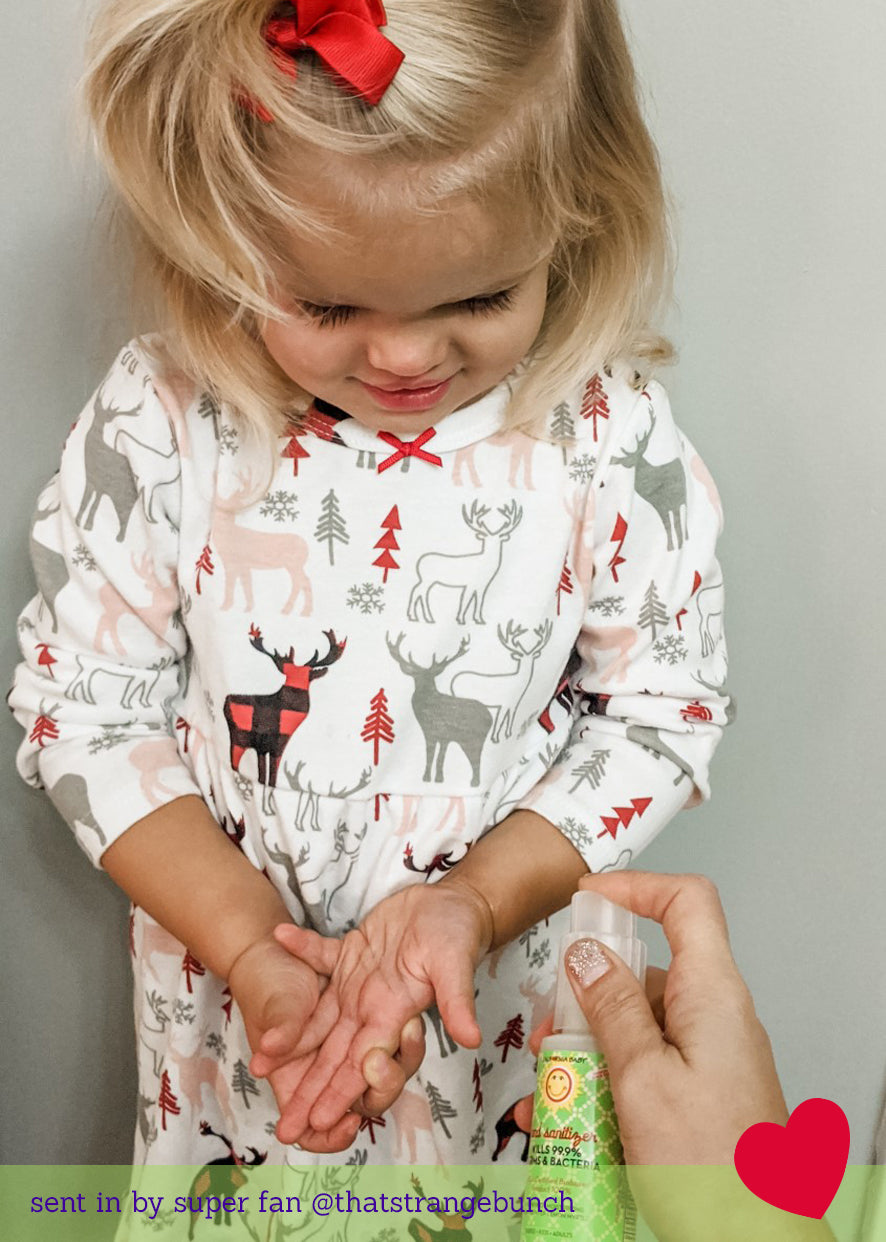 Child holding a small hand sanitizer bottle with pump, 59 mL.