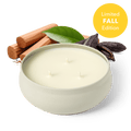 Three-wick candle in a white round jar with unlit wicks