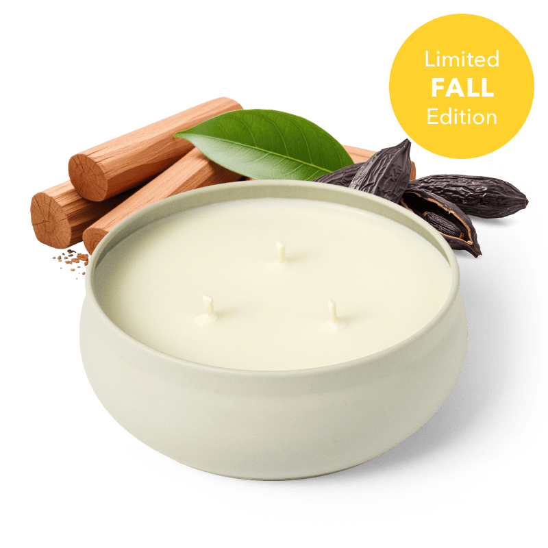 Three-wick candle in a white round jar with unlit wicks
