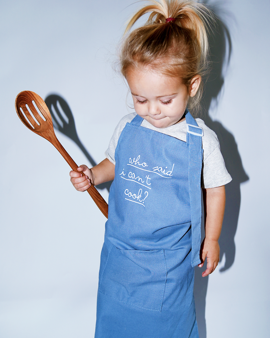 Kids blue chambray linen cooking apron with embroidered script front, adjustable straps