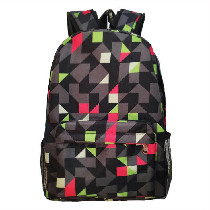 Luminous school backpack with black camo blocks and red/green accents, front zip pocket