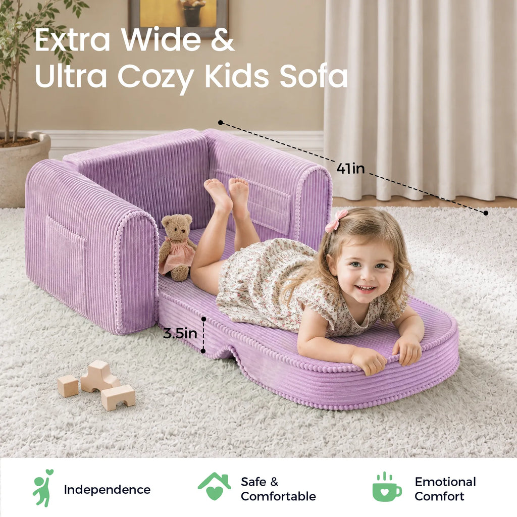 Purple corduroy kids sofa with wide low seat, rounded back, and pom-padded edge trim