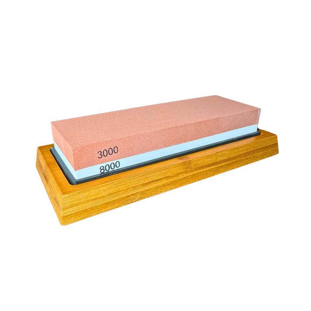 Two-sided sharpening stone with orange 3000 and 8000 grit on wood base