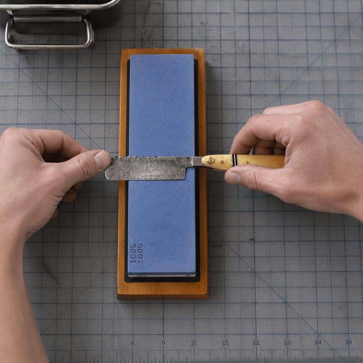 Two-sided sharpening stone with 1000 and 6000 grit labels
