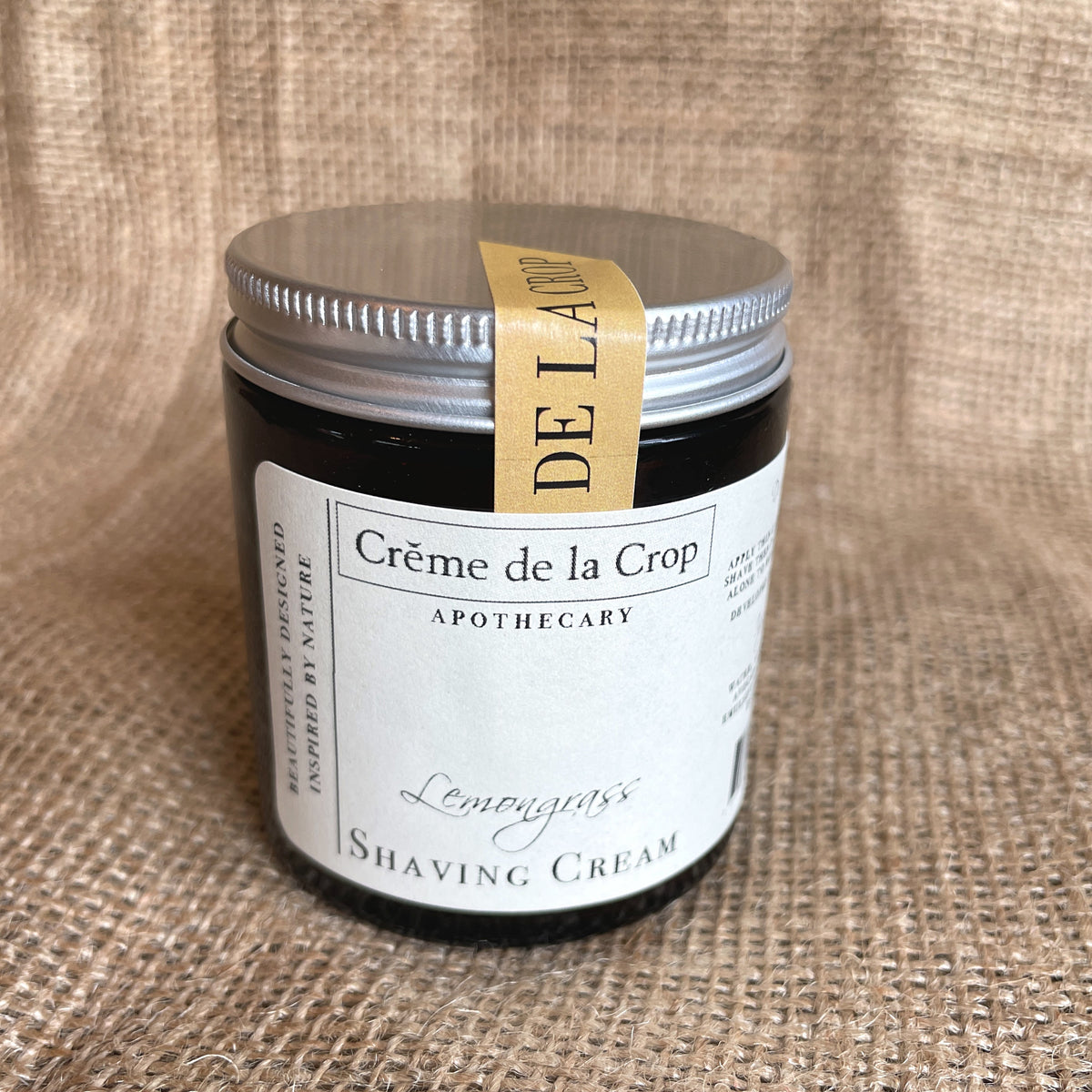 Moisturizing shaving cream jar with lemongrass label, silver lid