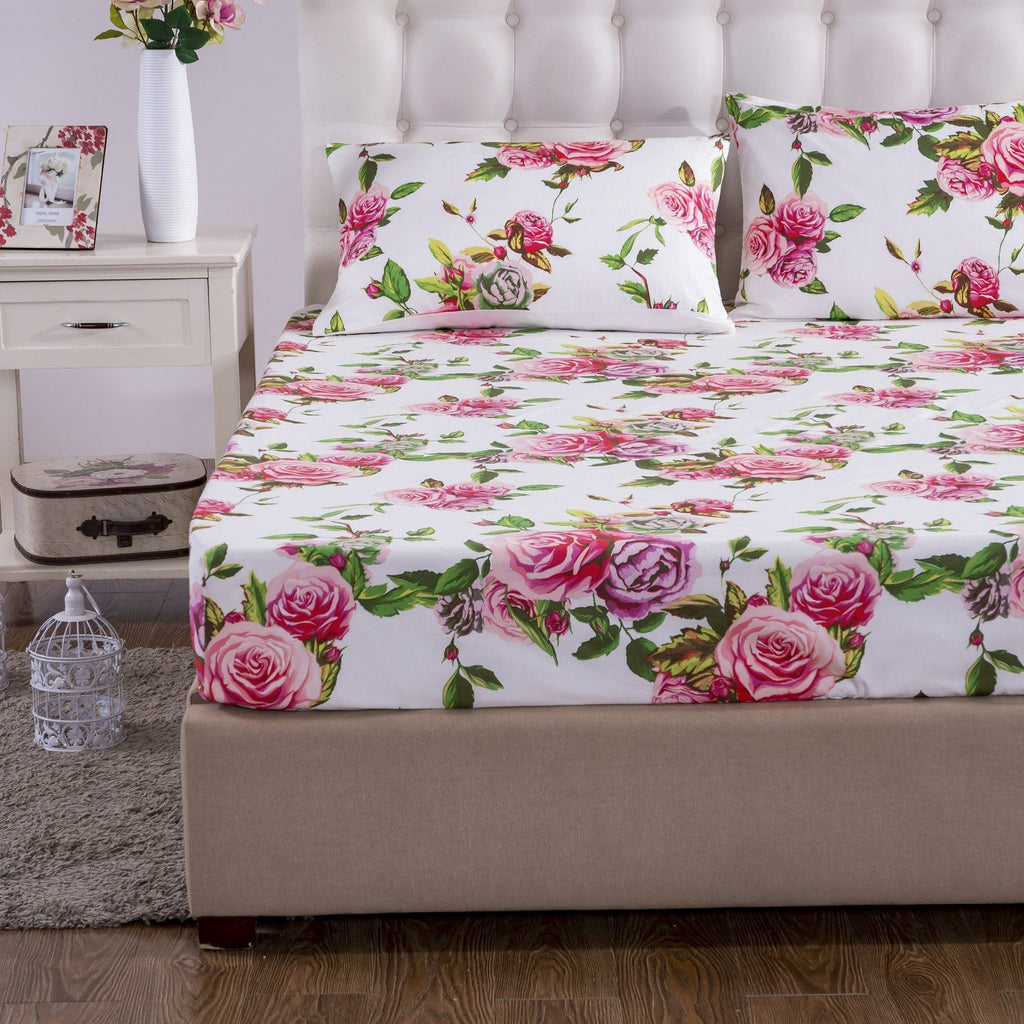 Floral fitted sheet with pink roses and green leaves on a white base