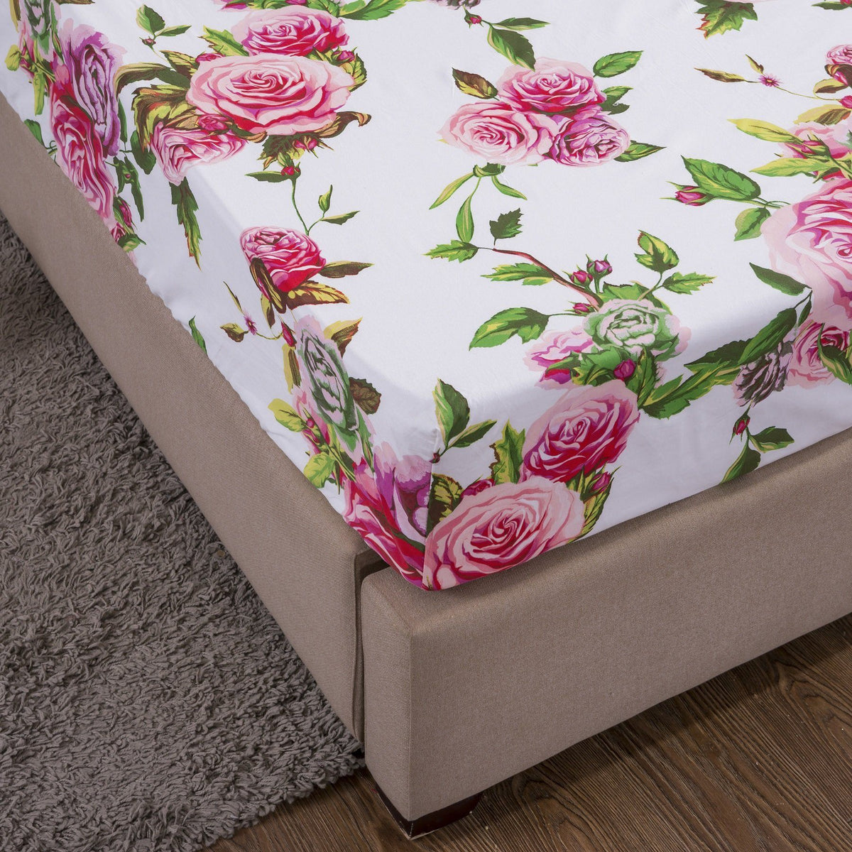 Pink rose floral fitted sheet corner with gray bed skirt and white base