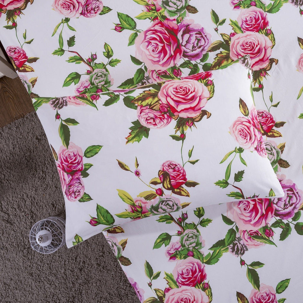 Pink rose floral pillowcase on bed with matching fitted sheet