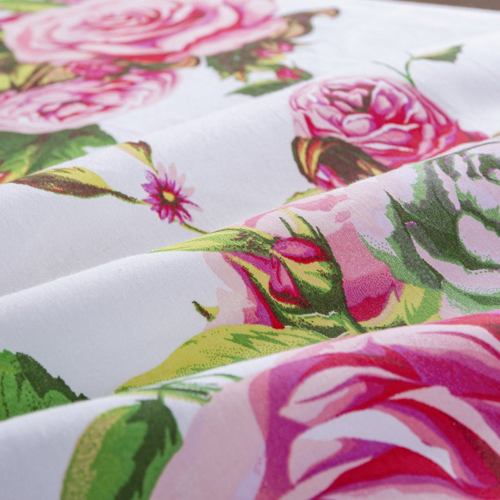 Pink rose floral print fabric swatch on white base with green leaves and stems