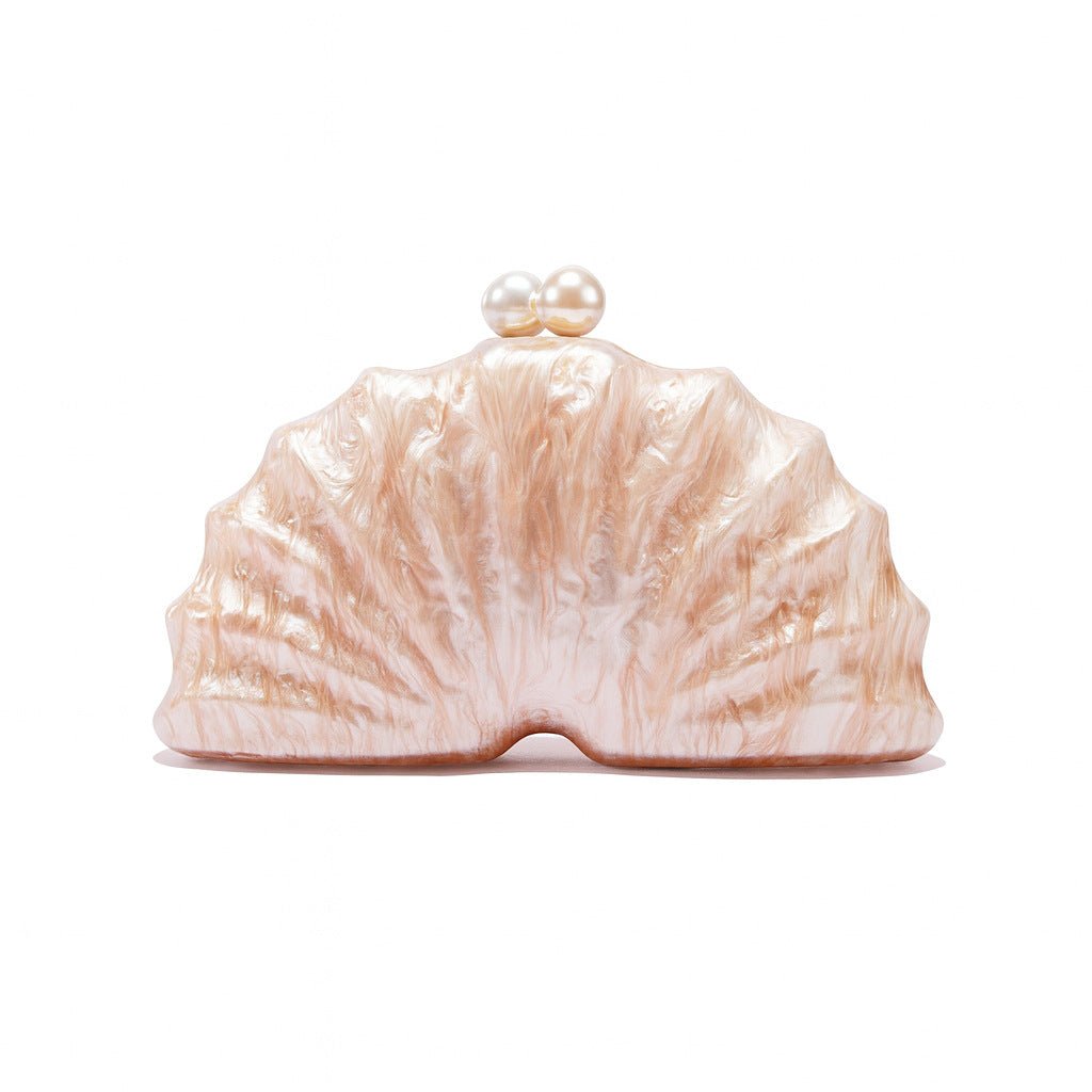 Champagne shell acrylic evening clutch with gathered top and pearl clasp