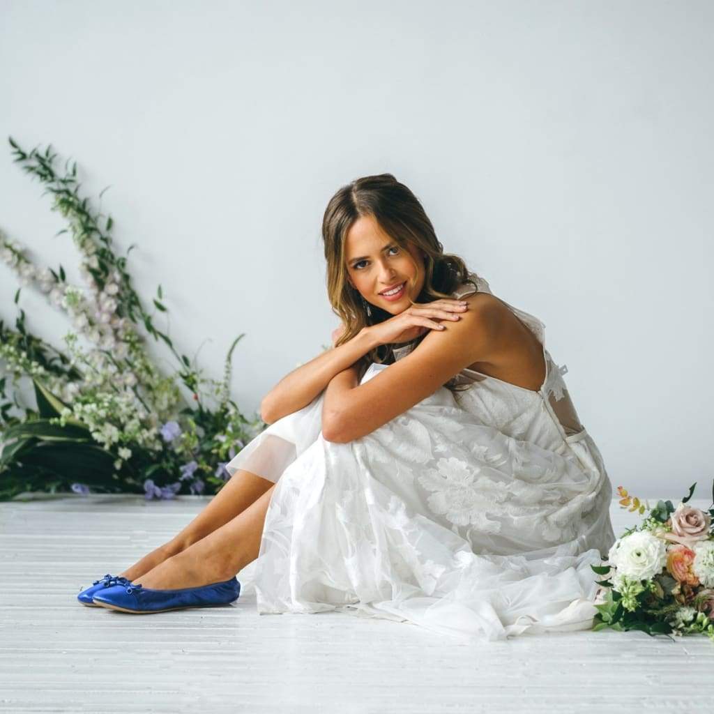 Cobalt blue flats worn with white dress; round toe ribbon lace-up design