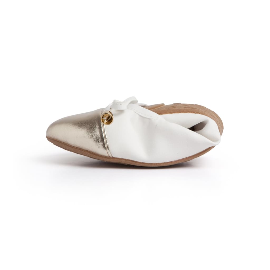 White and metallic ballet flats with bow tie vamp and low sole.