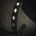 Black dog collar with teal piping and stitched geometric insets