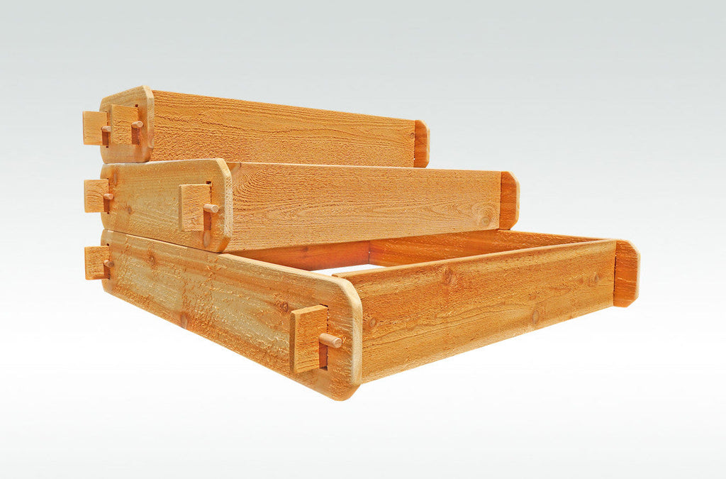 Three-tier raised cedar garden bed frame viewed from the side with joined corner brackets