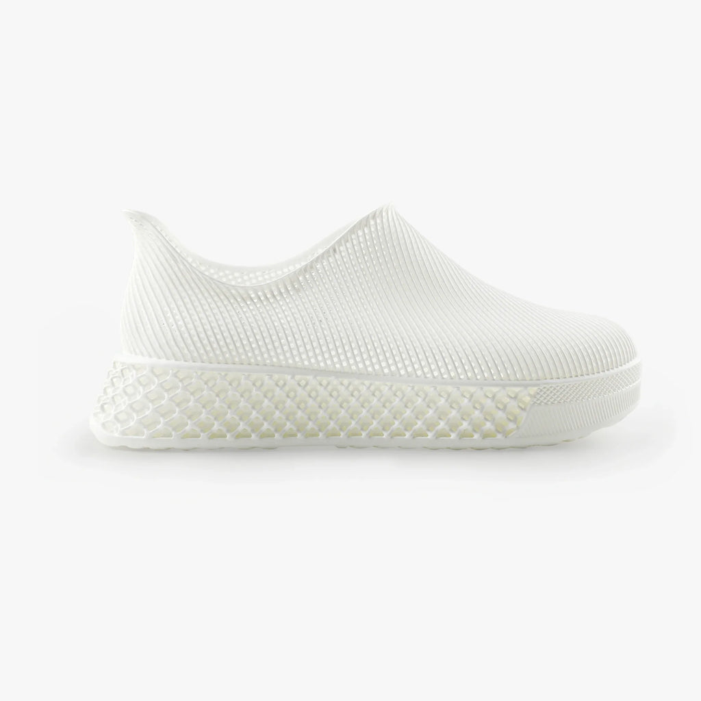 White 3D printed slip-on sneakers with textured upper and grippy rubber sole