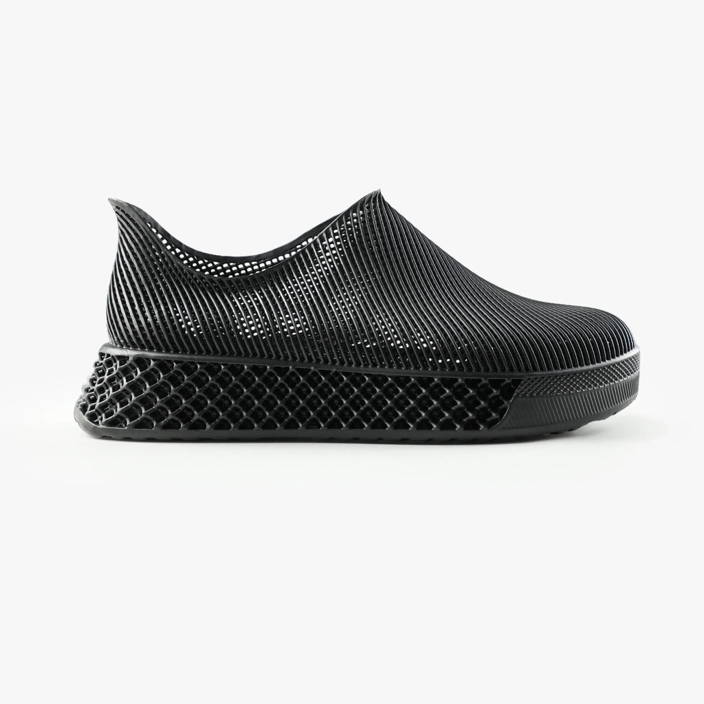 Black 3D printed slip-on sneakers with textured sidewall and black rubber sole