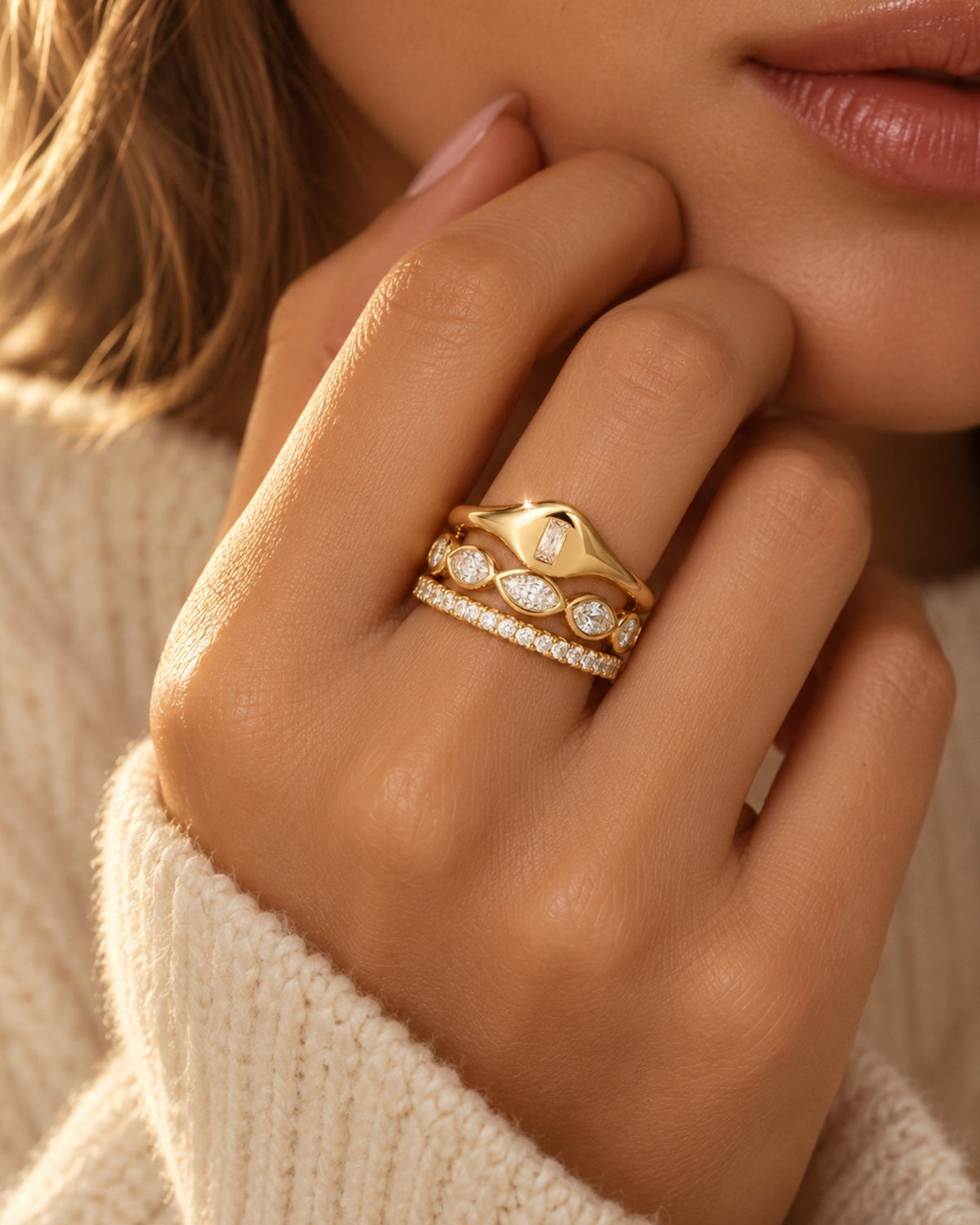 Gold marquise eternity band with sparkling clear gemstone settings on finger
