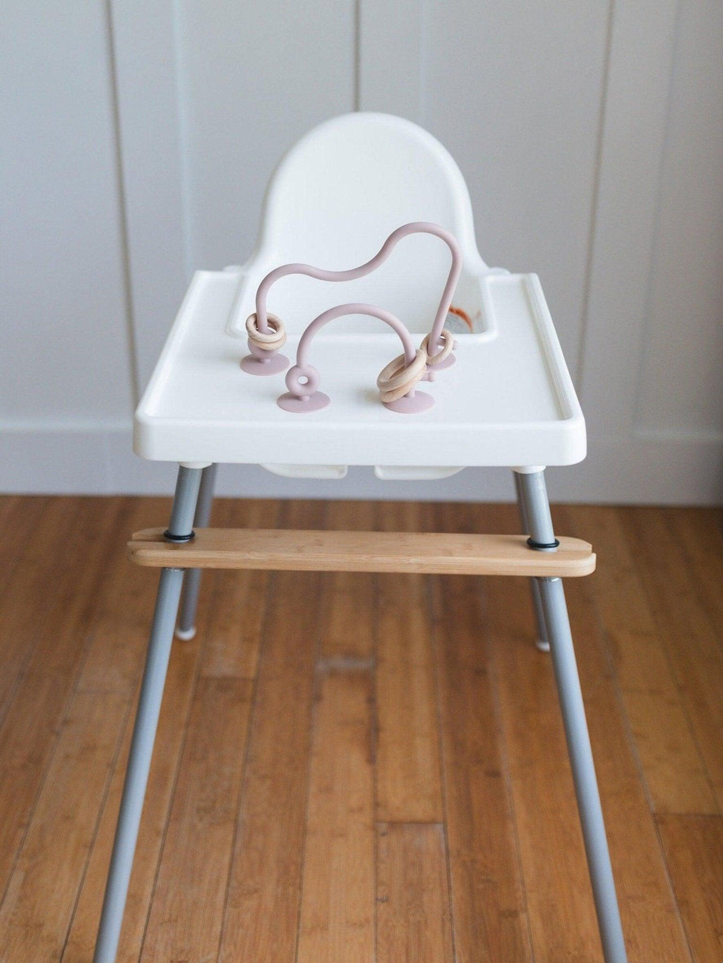 Silicone highchair toy set with dusty rose loop arches and hanging rings on tray