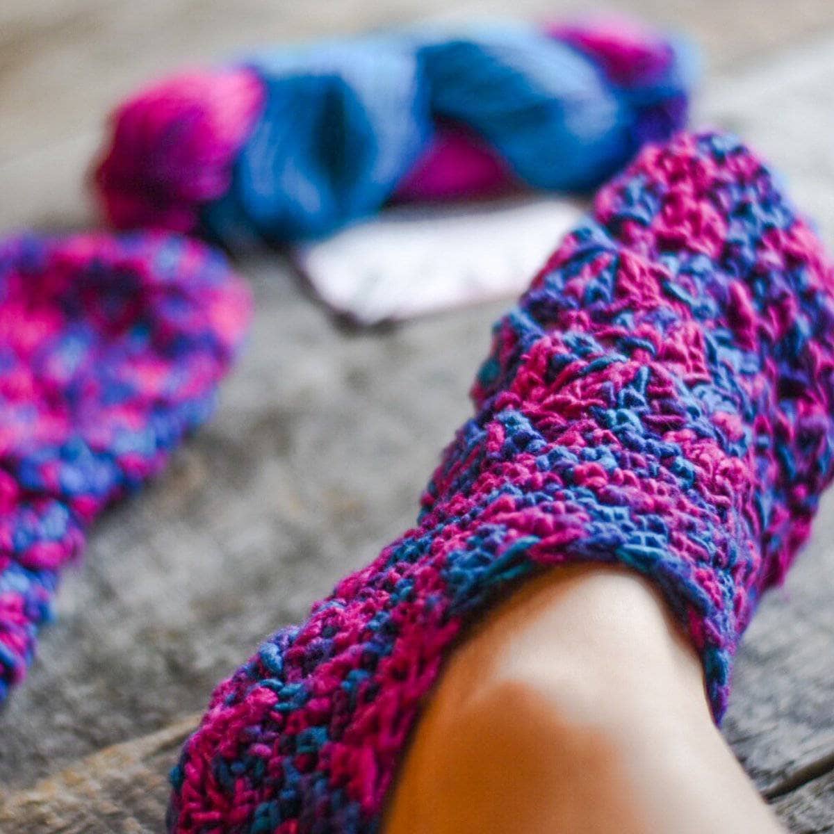 Crocheted slipper with blue and magenta chunky knit and pointed toe