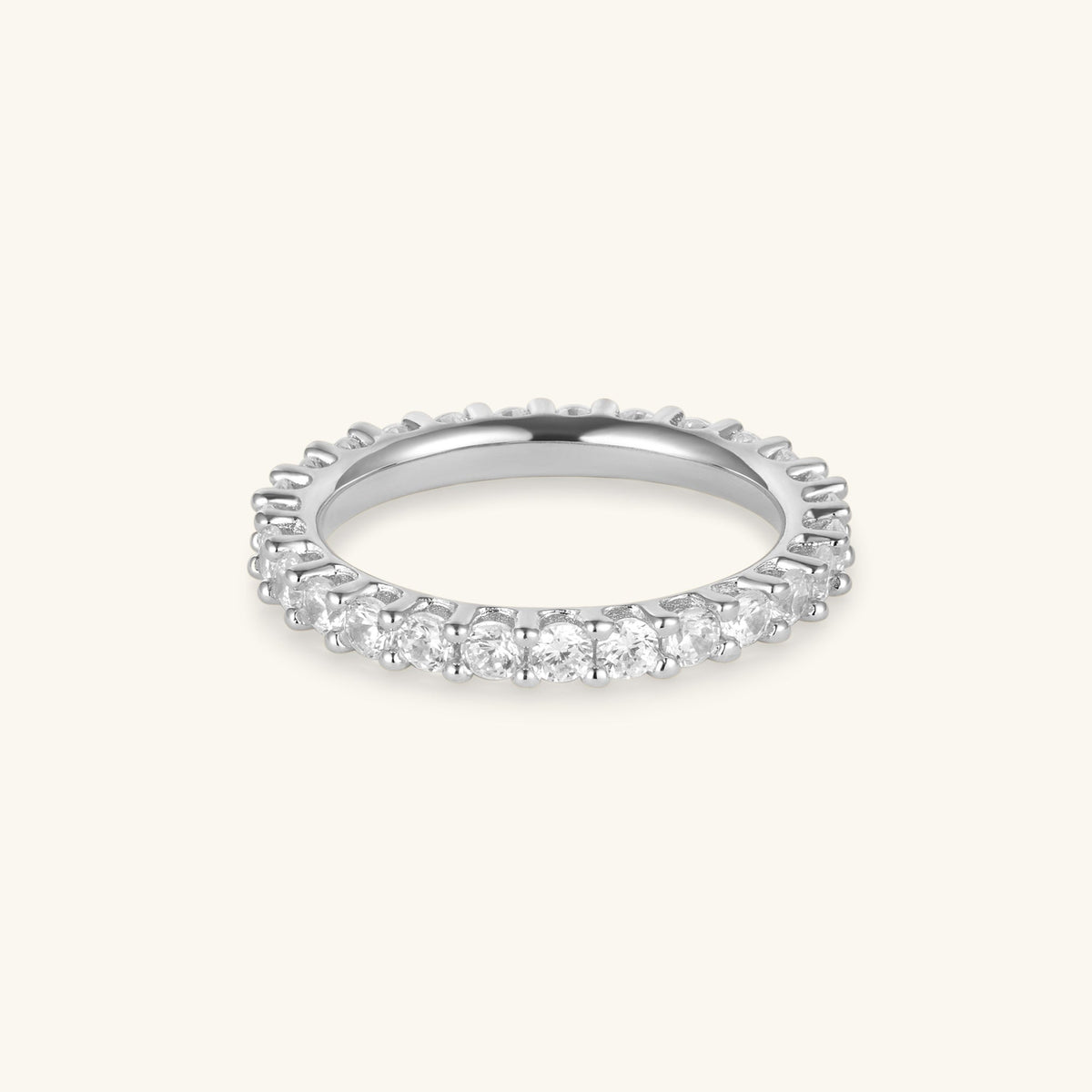 Silver eternity ring with round prong-set stones along the band