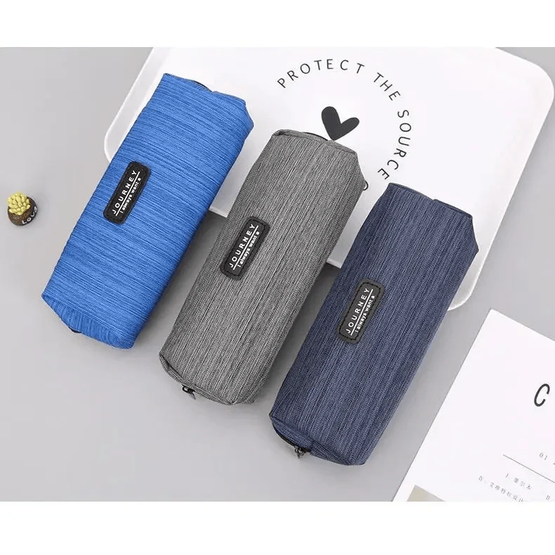 Small square waterproof pencil cases in blue, navy, and gray with zipper and brand label