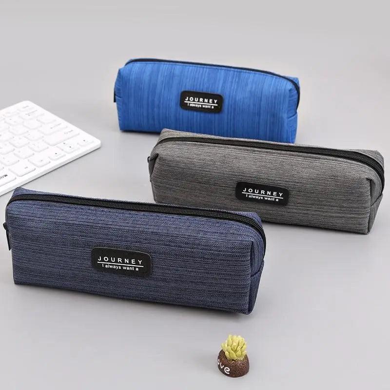 Small waterproof pencil cases, blue and gray tones, each with zipper and brand patch